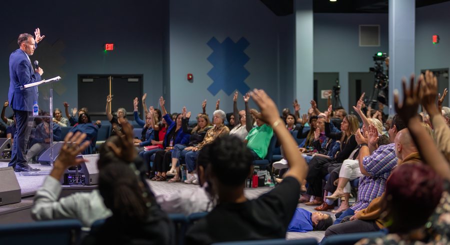 A congregation with hands raised in worship